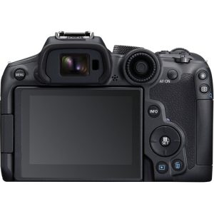 A Canon EOS R7 mirrorless camera with a black body and a mounted lens, placed on a flat surface, showcasing its sleek design and professional features.