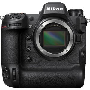 A high-end Nikon Z9 mirrorless camera with a robust build, featuring a large lens, electronic viewfinder, and a sleek black design, positioned on a flat surface.