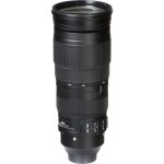 A close-up of the Nikon AF-S NIKKOR 200-500mm f/5.6E ED VR telephoto zoom lens, showcasing its large barrel, zoom ring, and gold 'NIKKOR' branding. The lens is mounted on a Nikon DSLR camera, ready for action photography.
