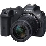 A Canon EOS R7 mirrorless camera with a black body and a mounted lens, placed on a flat surface, showcasing its sleek design and professional features.