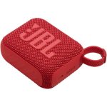 A compact red JBL Go 4 portable Bluetooth speaker with a fabric-covered design, rubberized edges, and a built-in carrying loop, resting on a flat surface.