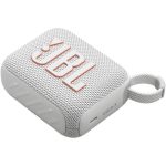 A compact red JBL Go 4 portable Bluetooth speaker with a fabric-covered design, rubberized edges, and a built-in carrying loop, resting on a flat surface.