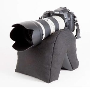 SafariSack bean bag for wildlife photography supporting a DSLR camera on a car door in Kenya